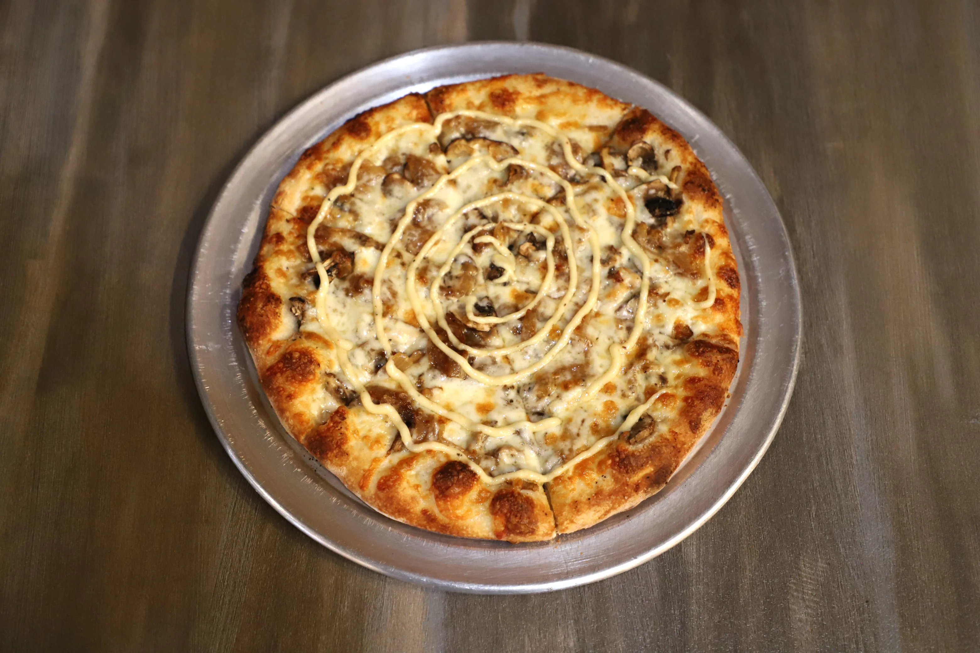 Savory pizza topped with mushrooms and creamy sauce