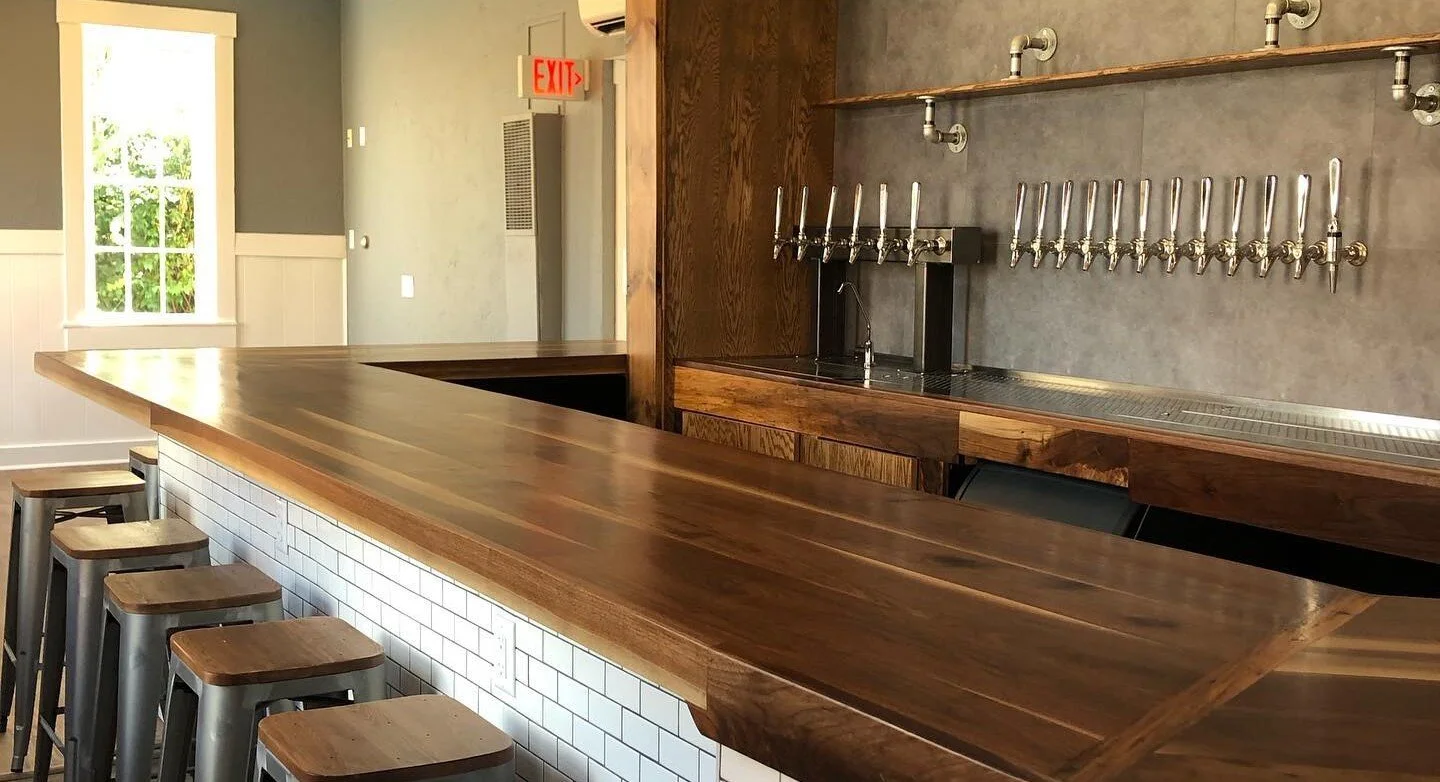 Modern bar counter with wooden finish and beer taps