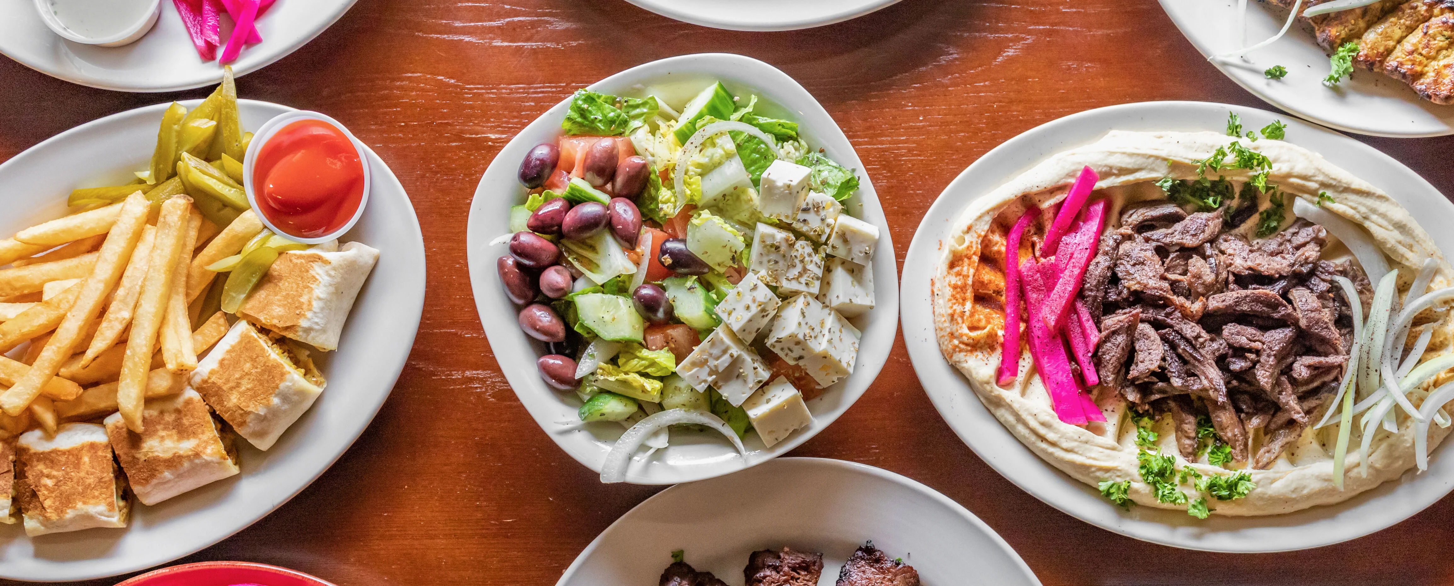 Assorted Middle Eastern mezze platter with grilled meats and fresh salads