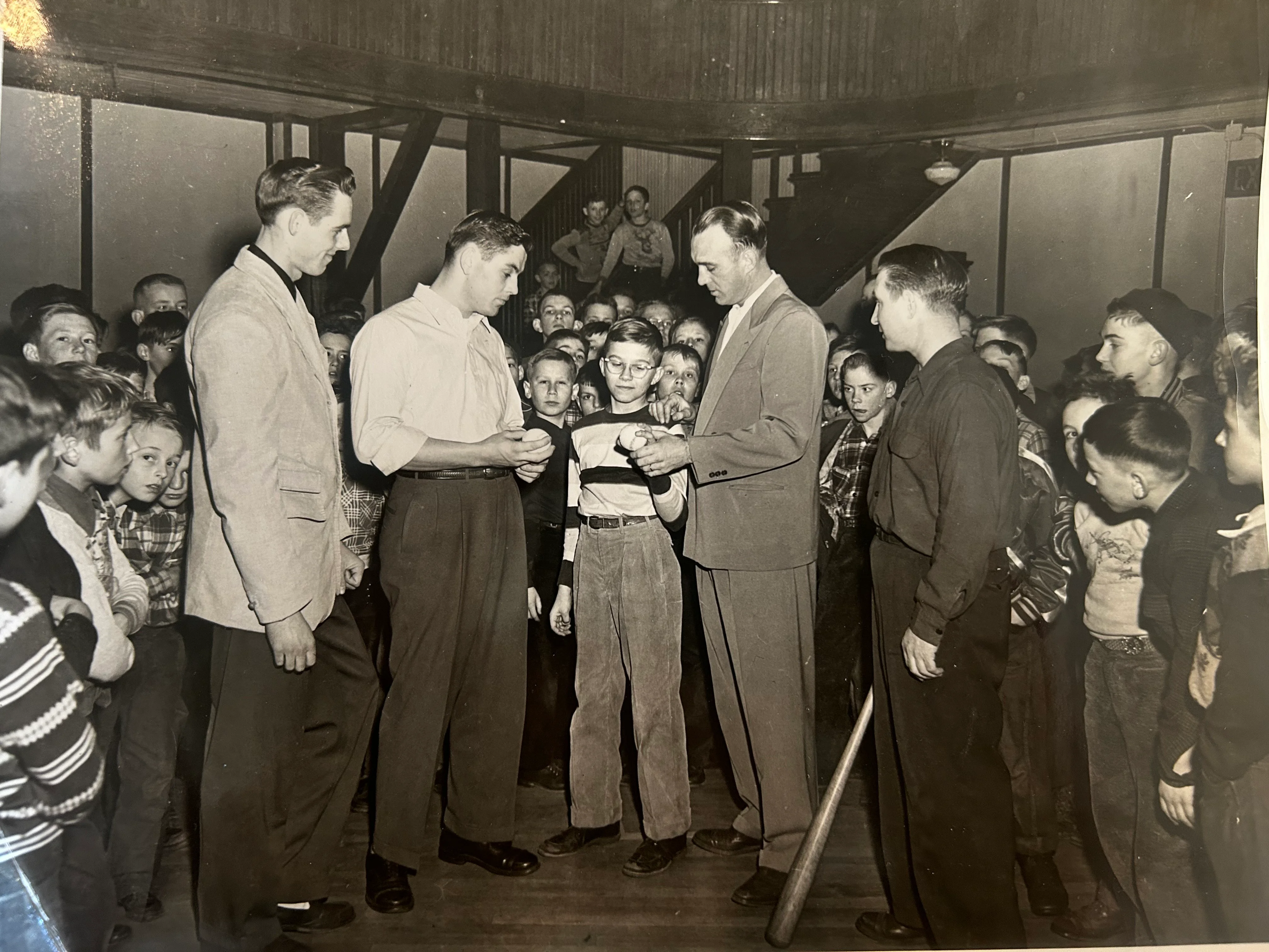 Historical gathering of children with adults in a community setting