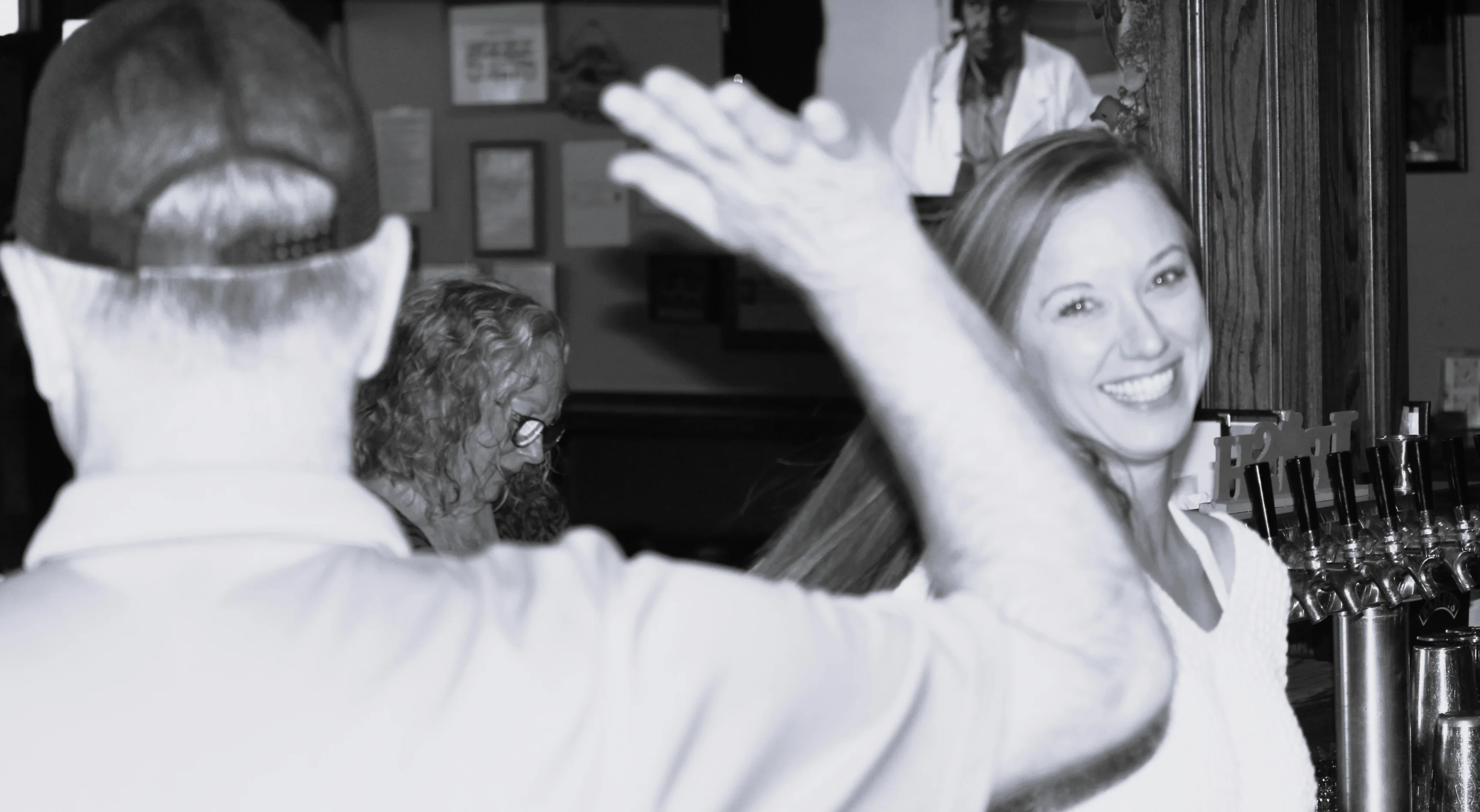 Smiling woman in a lively restaurant atmosphere