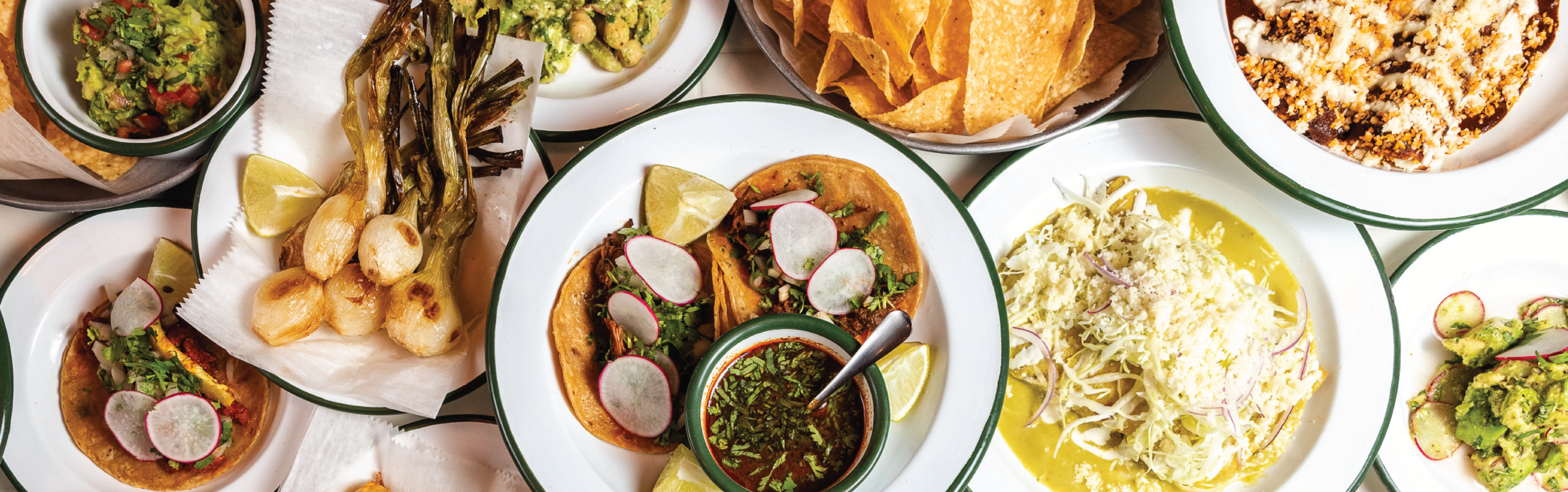 Colorful Mexican taco platter with guacamole and salsas