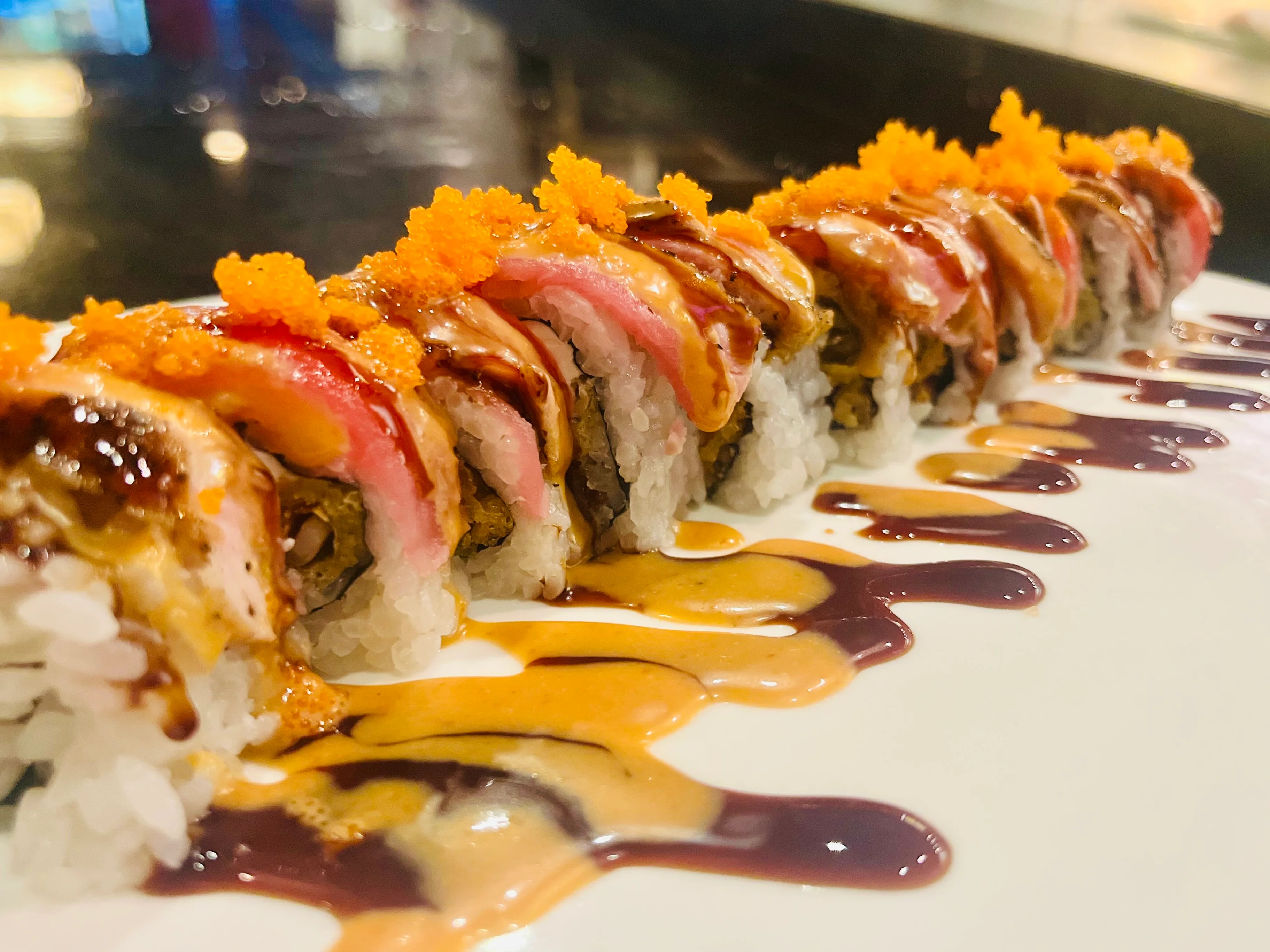 Colorful sushi roll with spicy sauce and fish roe