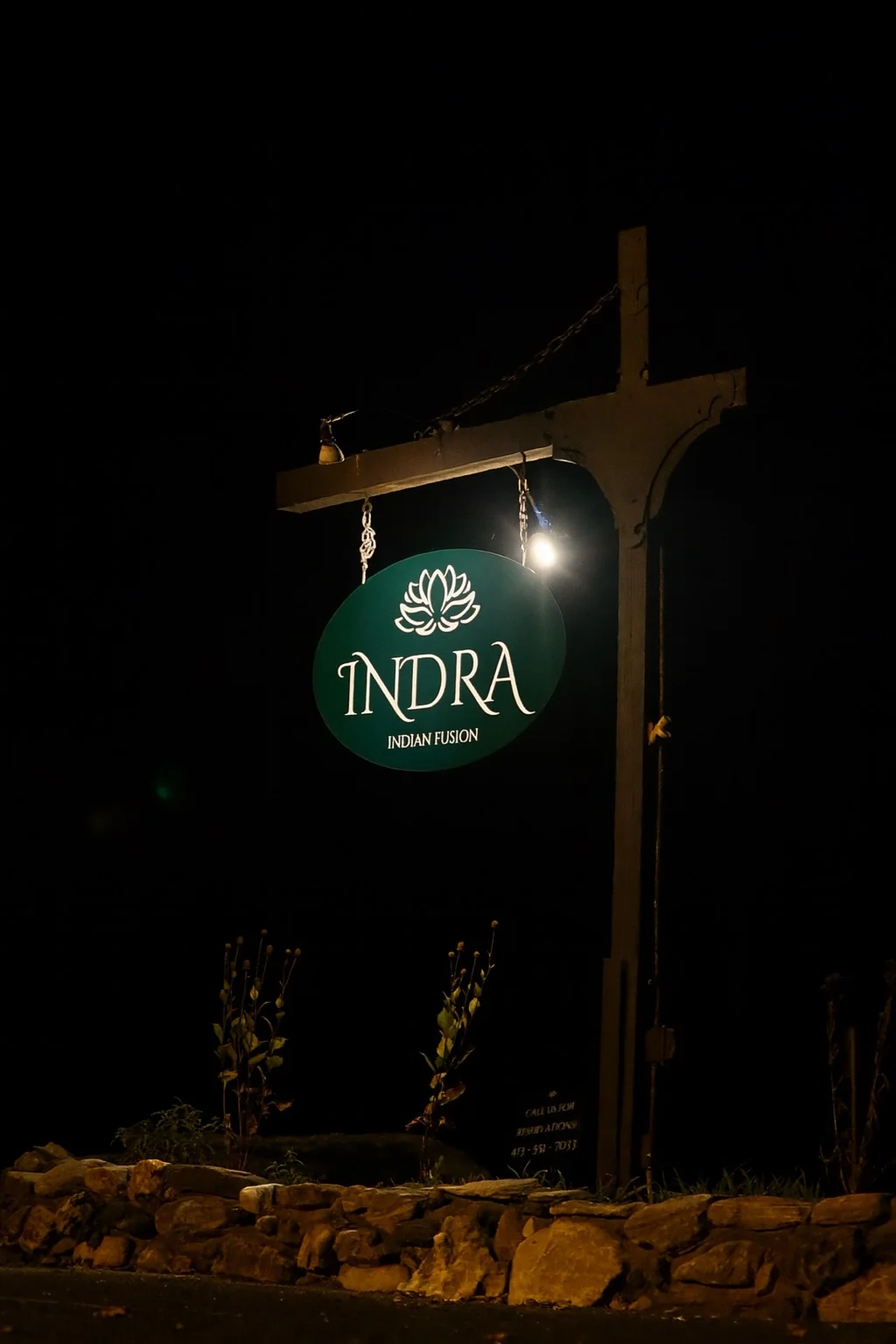 Sign for Indra Indian Fusion restaurant at night