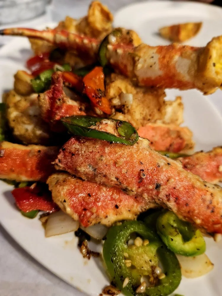 Crispy fried crab legs with peppers and onions