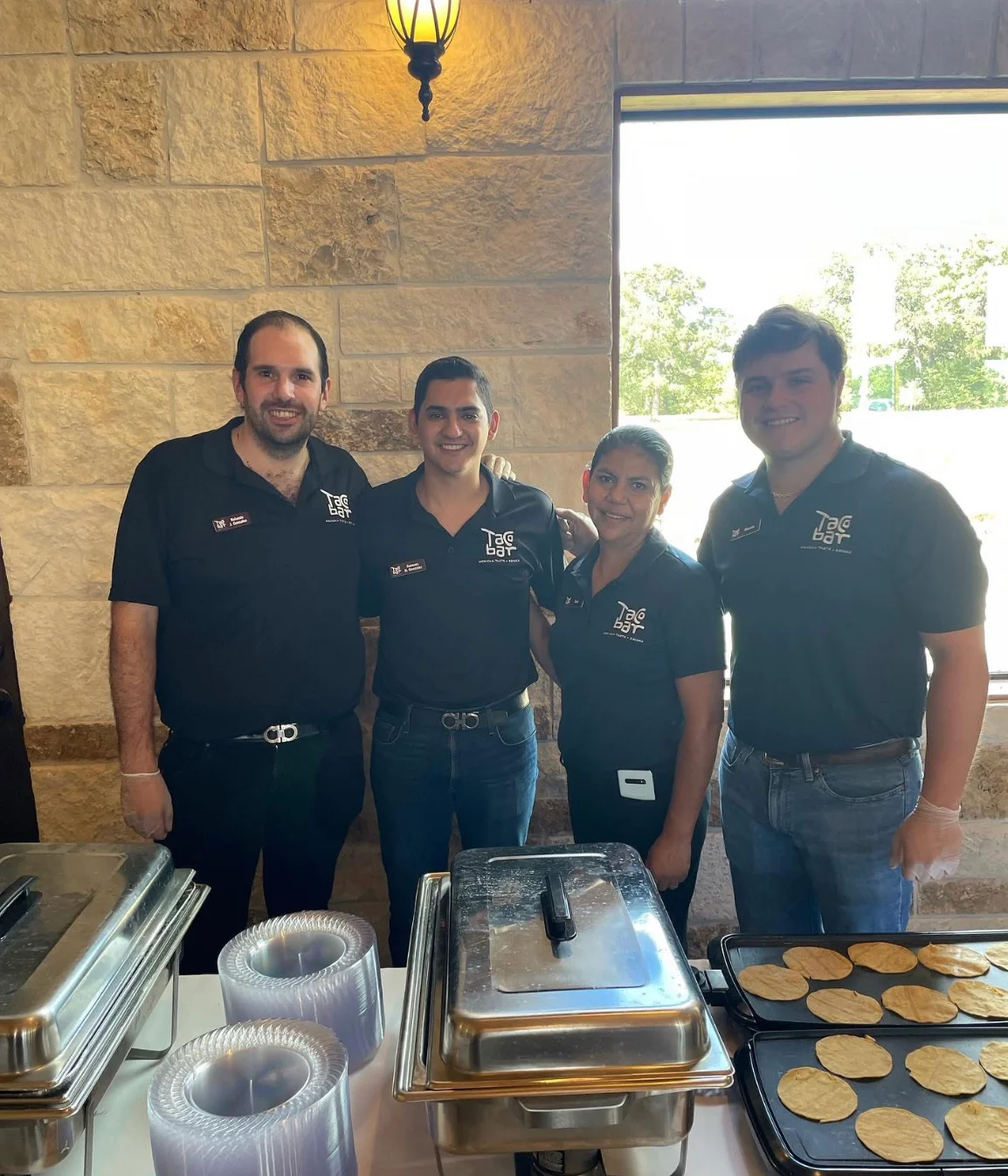 Catering team preparing fresh tortillas at a restaurant event