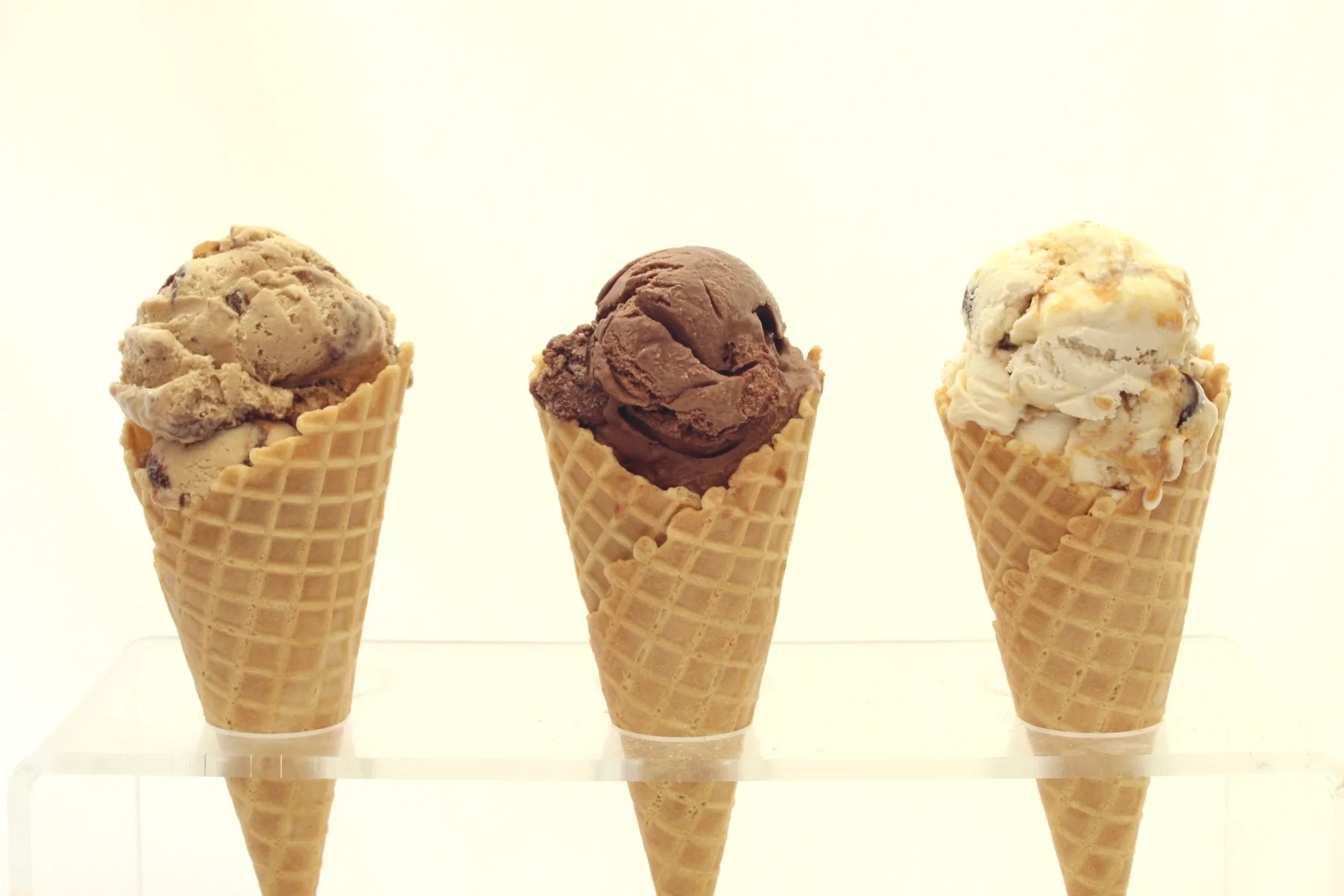 Three ice cream cones with different flavors