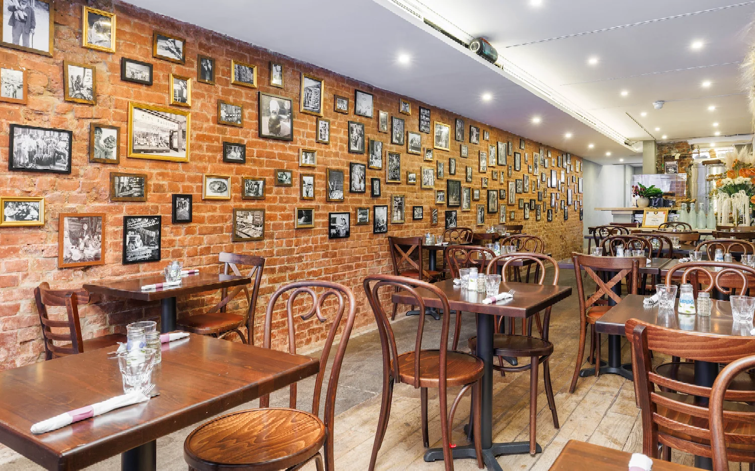 Cozy restaurant interior with exposed brick and vintage photo gallery