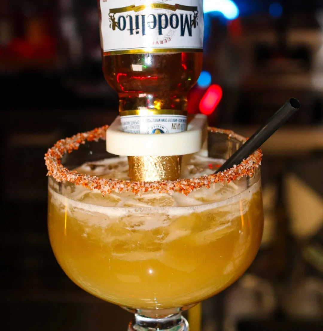 Colorful margarita cocktail with a beer bottle
