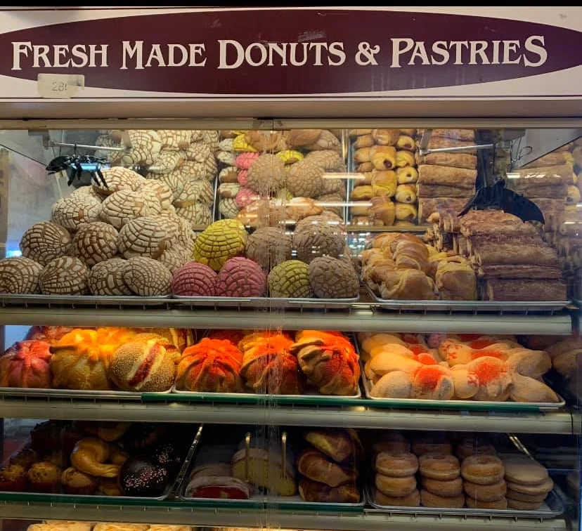 Assorted Mexican pastries and donuts in a display case