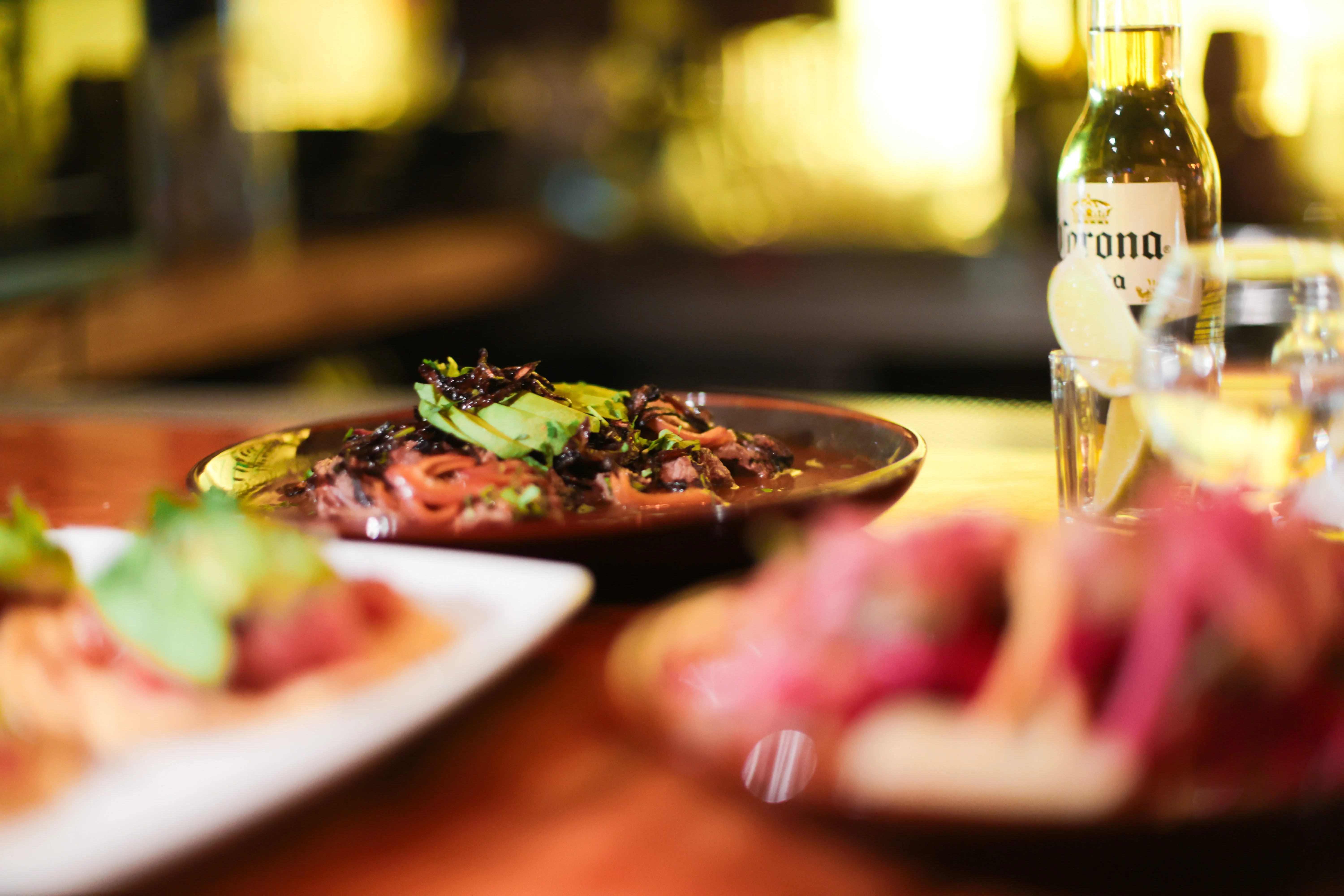 A vibrant dish of ribeye aquachiles garnished with fresh ingredients.