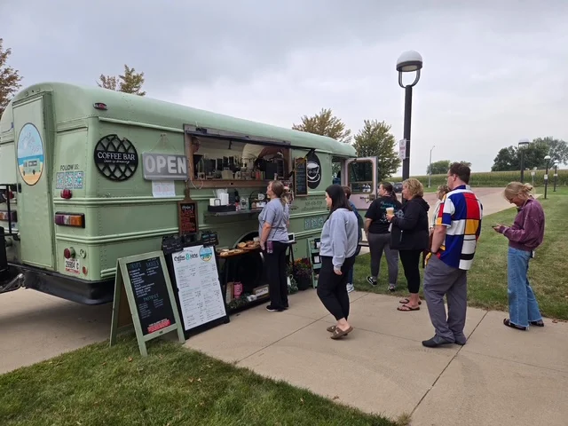 Coffee truck serving customers in a park setting