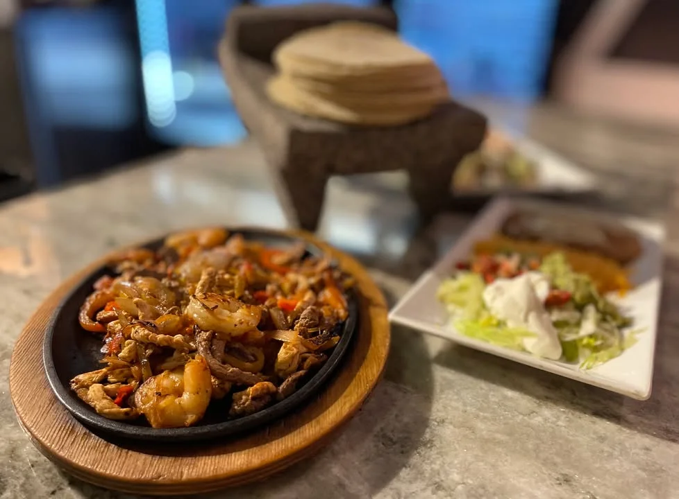 Sizzling fajitas served on a hot skillet