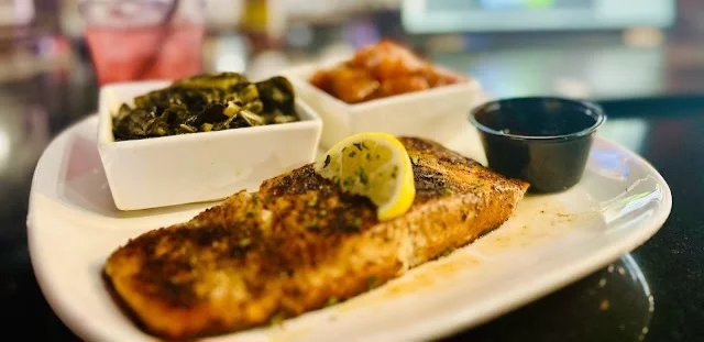 Grilled salmon with sides of collard greens and sweet potatoes
