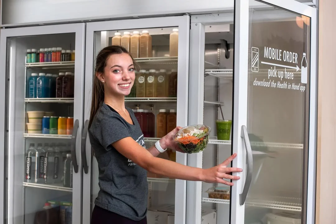 Employee with a fresh salad in a modern restaurant setting