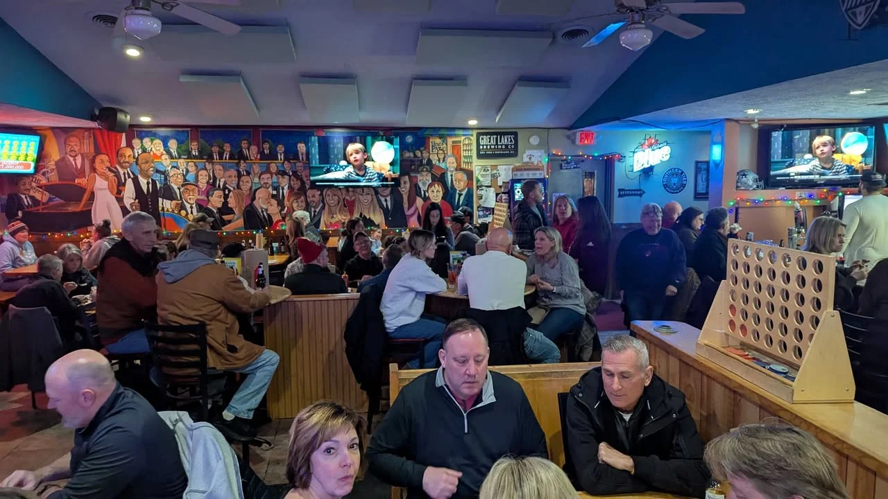 Lively restaurant interior with colorful murals and patrons enjoying meals
