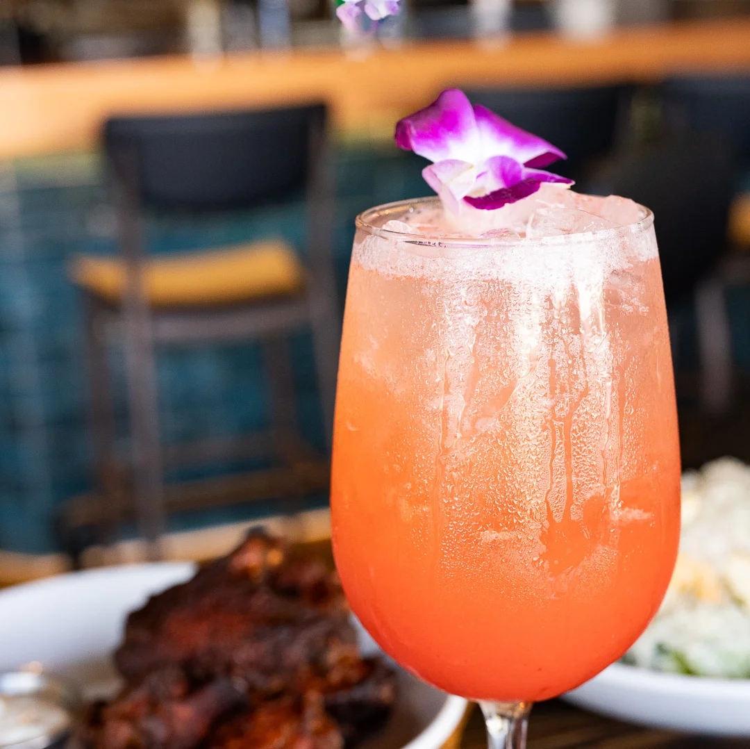 Colorful tropical cocktail garnished with a flower