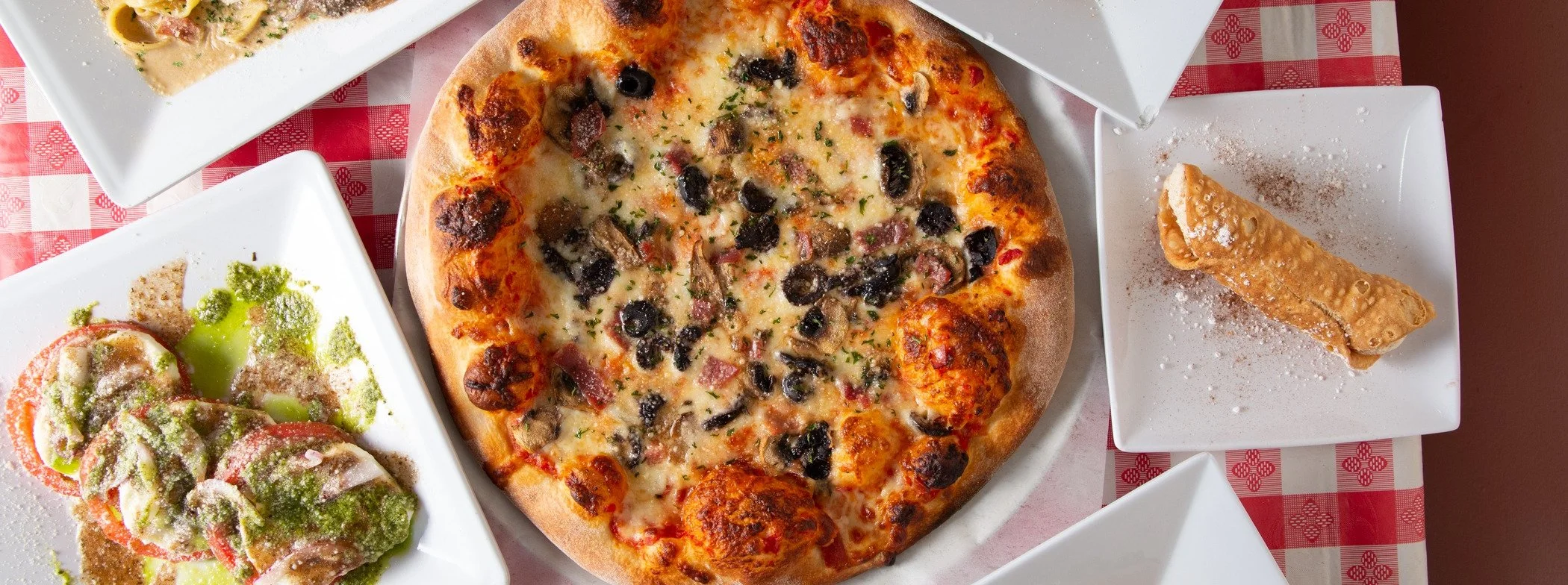 Italian pizza with olives and a side of cannoli