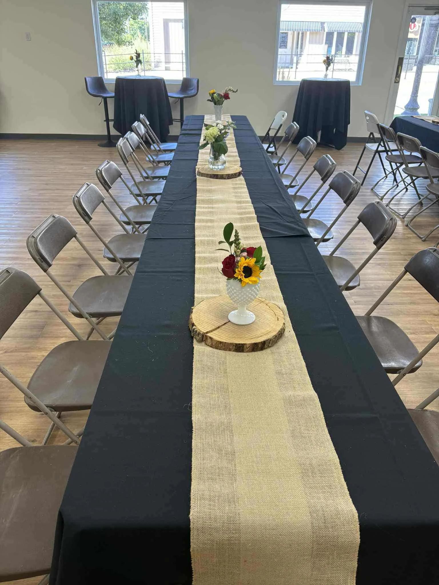 Elegant dining setup with floral centerpieces and black tablecloths