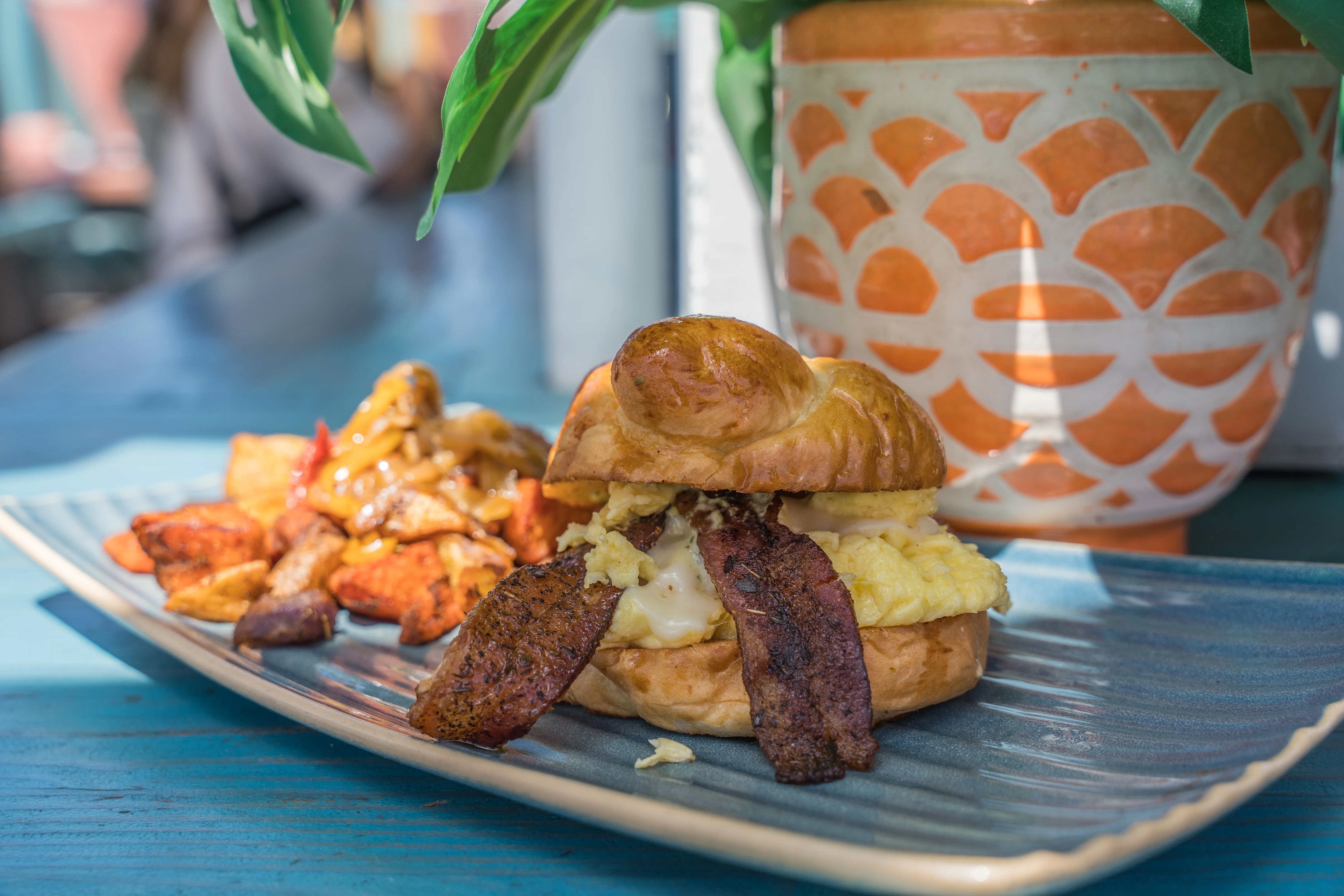 Breakfast sandwich with eggs and bacon on a croissant