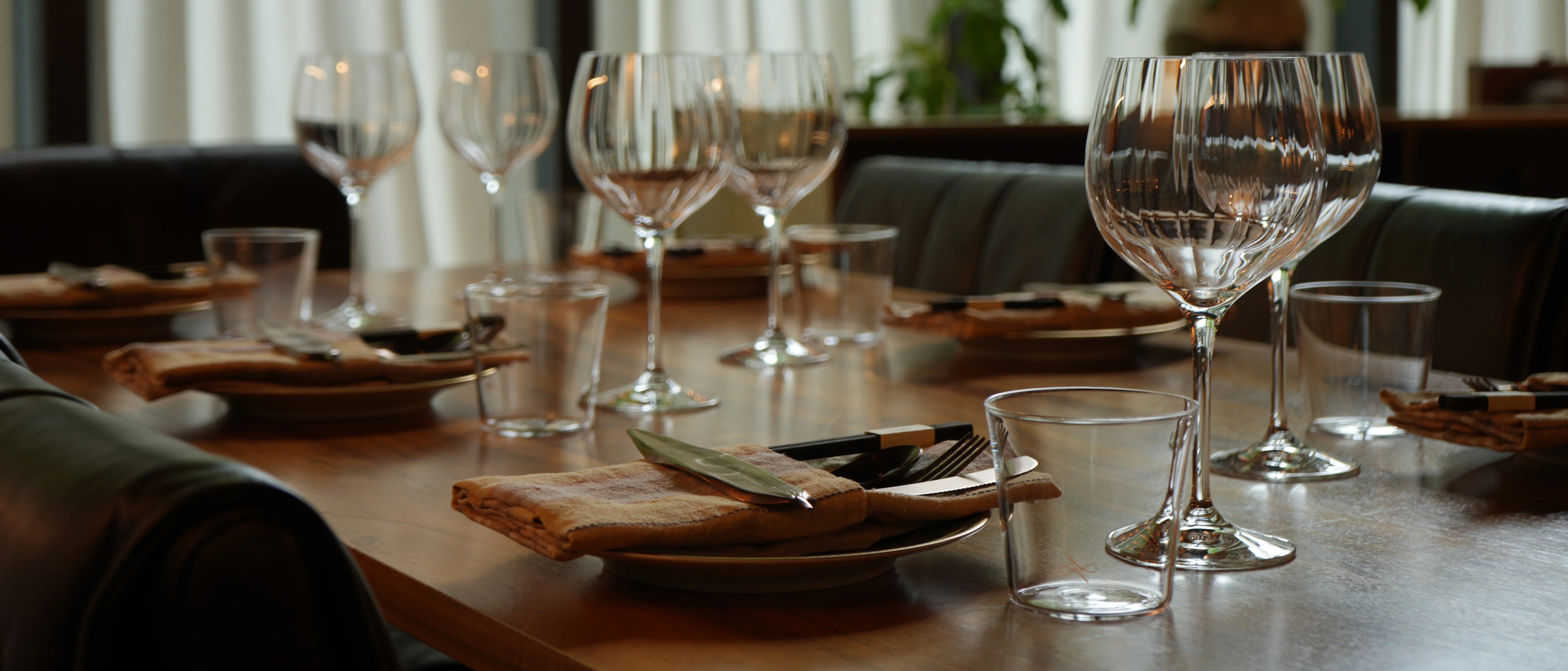 Elegant restaurant table set for dining with glassware and cutlery