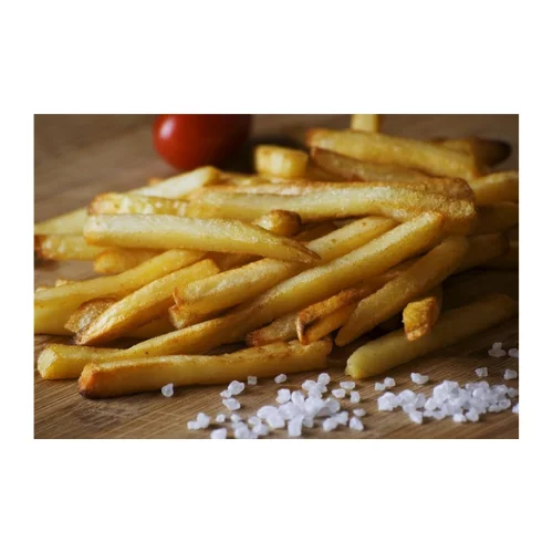 Crispy French fries with sea salt on a wooden board