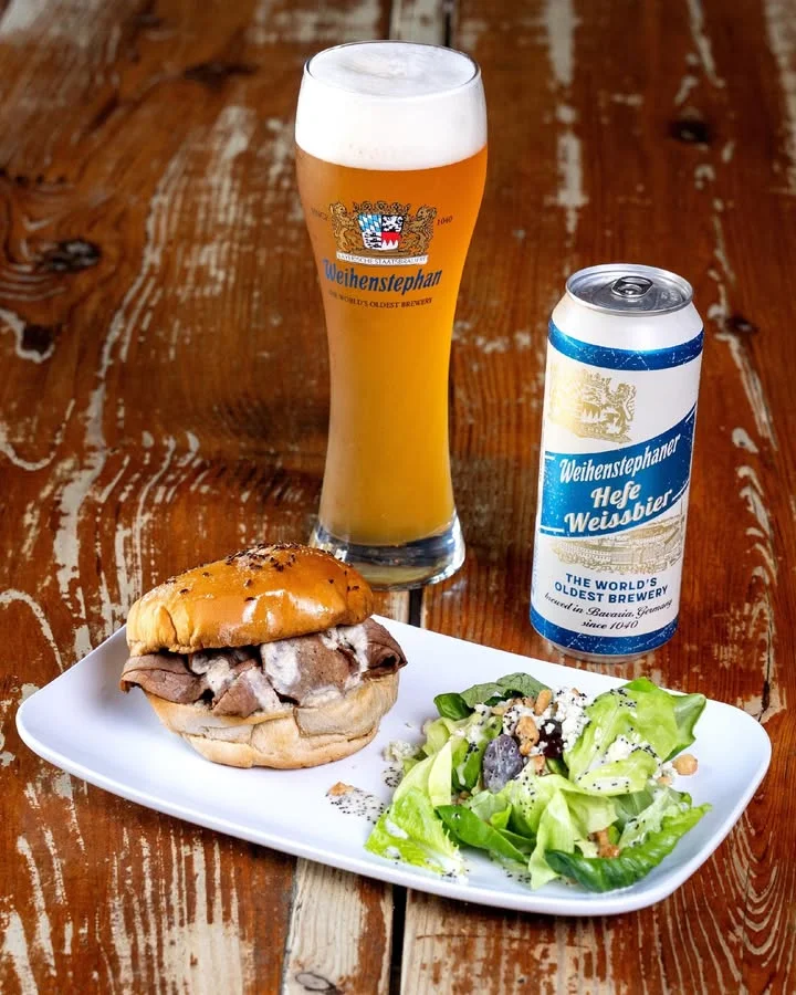 German roast beef sandwich with salad and Weihenstephan beer