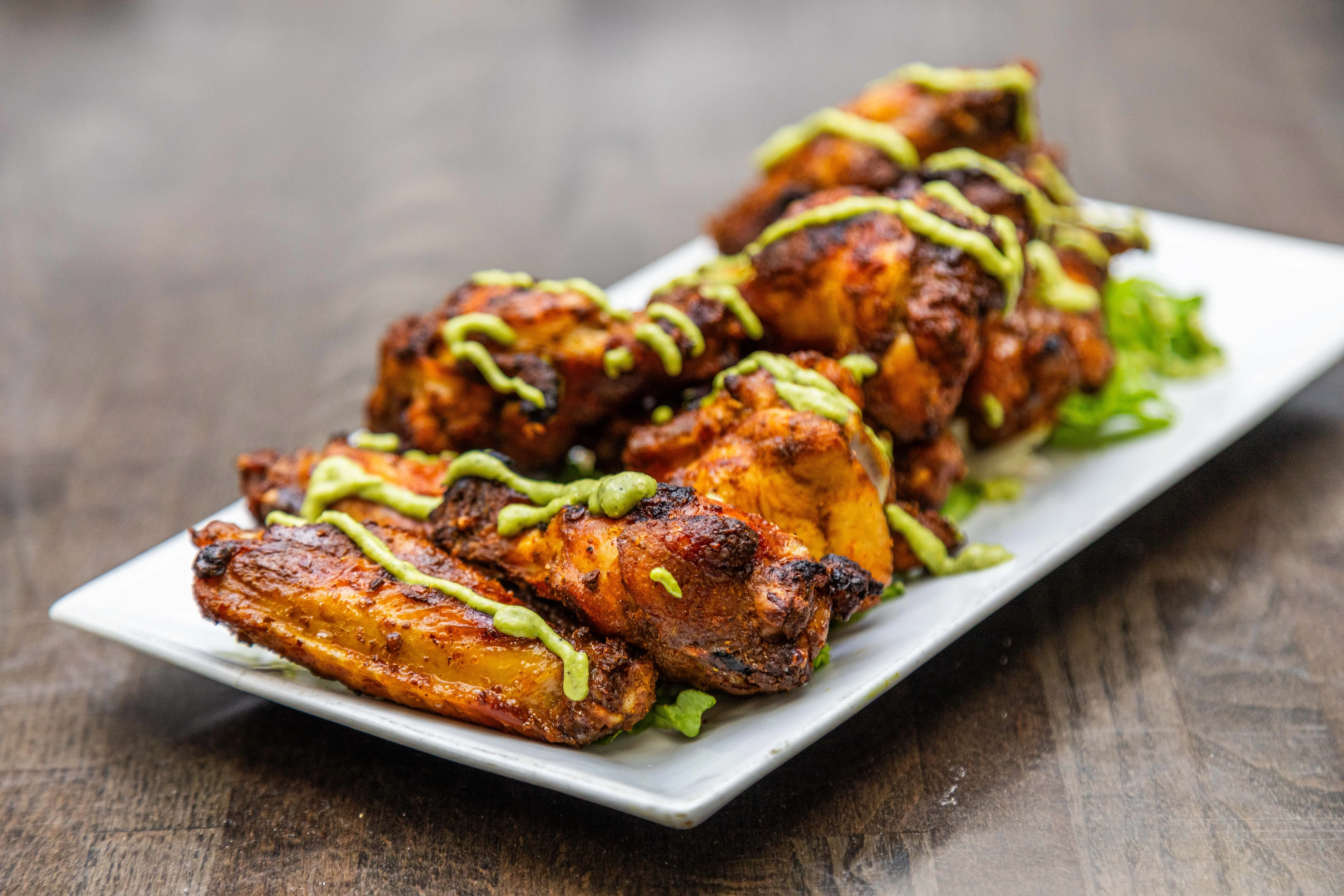Spicy Indian tandoori chicken wings with green sauce