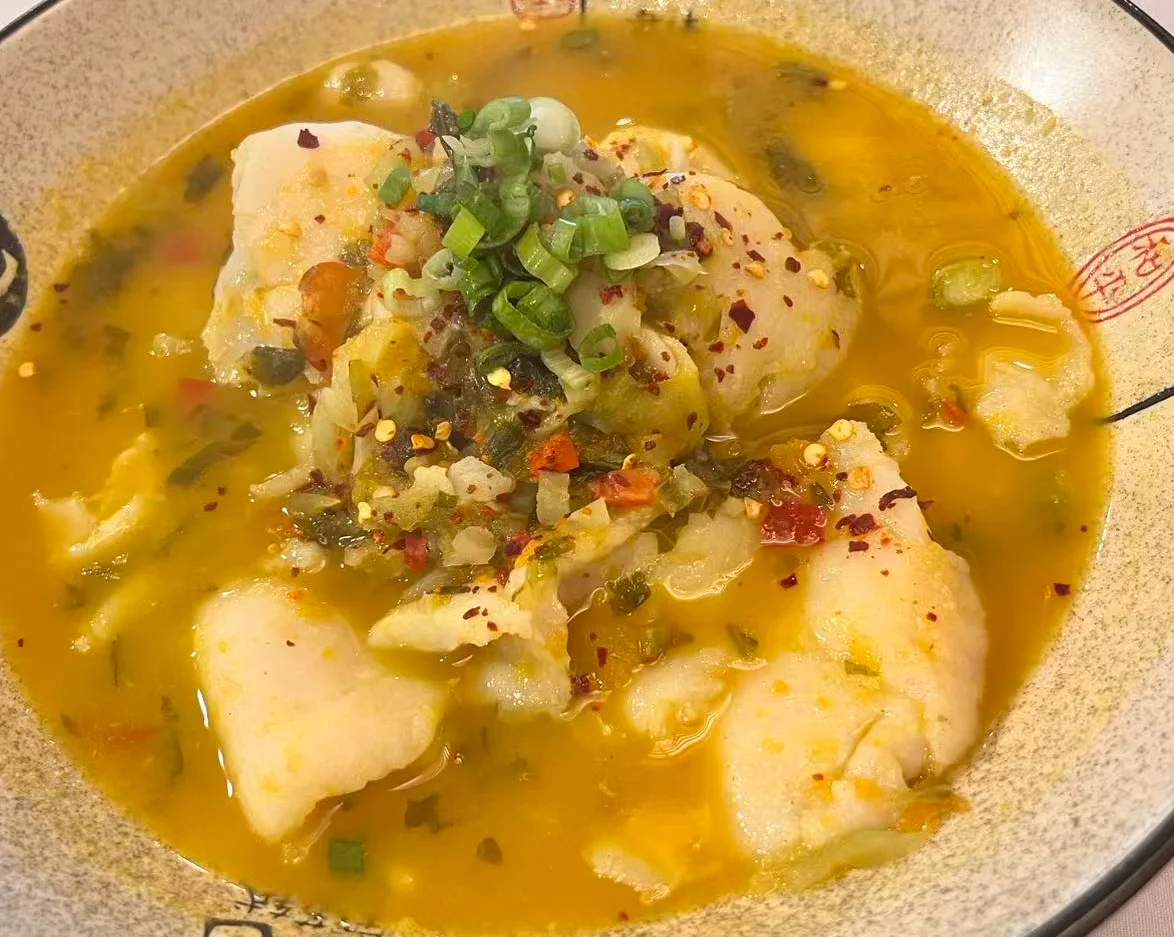 Chinese fish soup with spicy broth and herbs