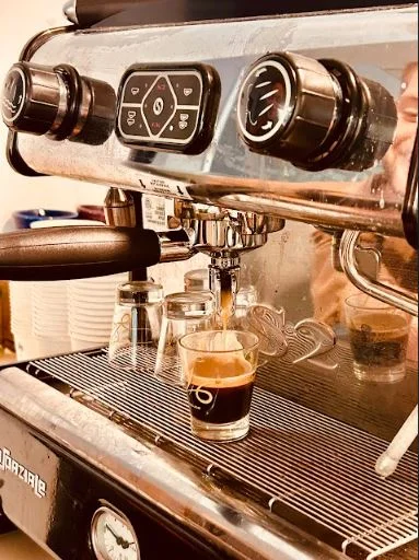 Espresso shot being brewed in a coffee machine
