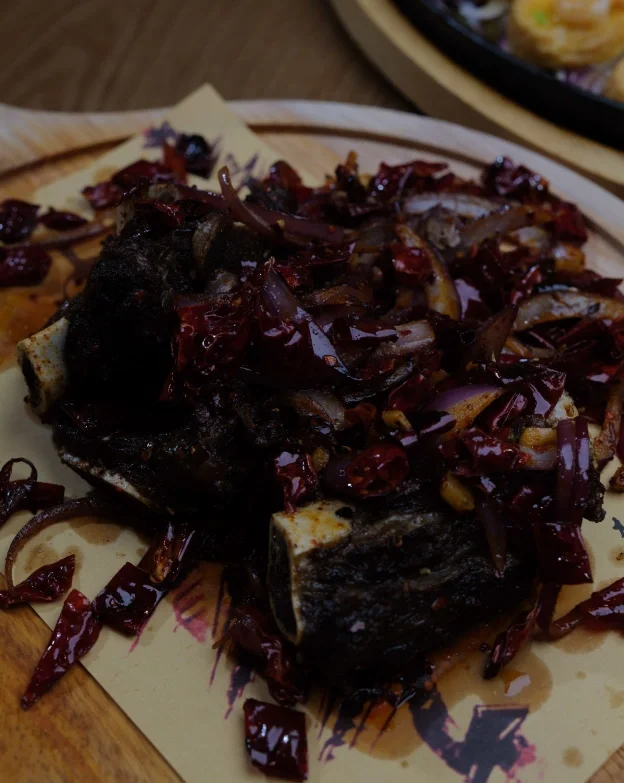 Spicy Chinese braised beef short ribs with chili and onions