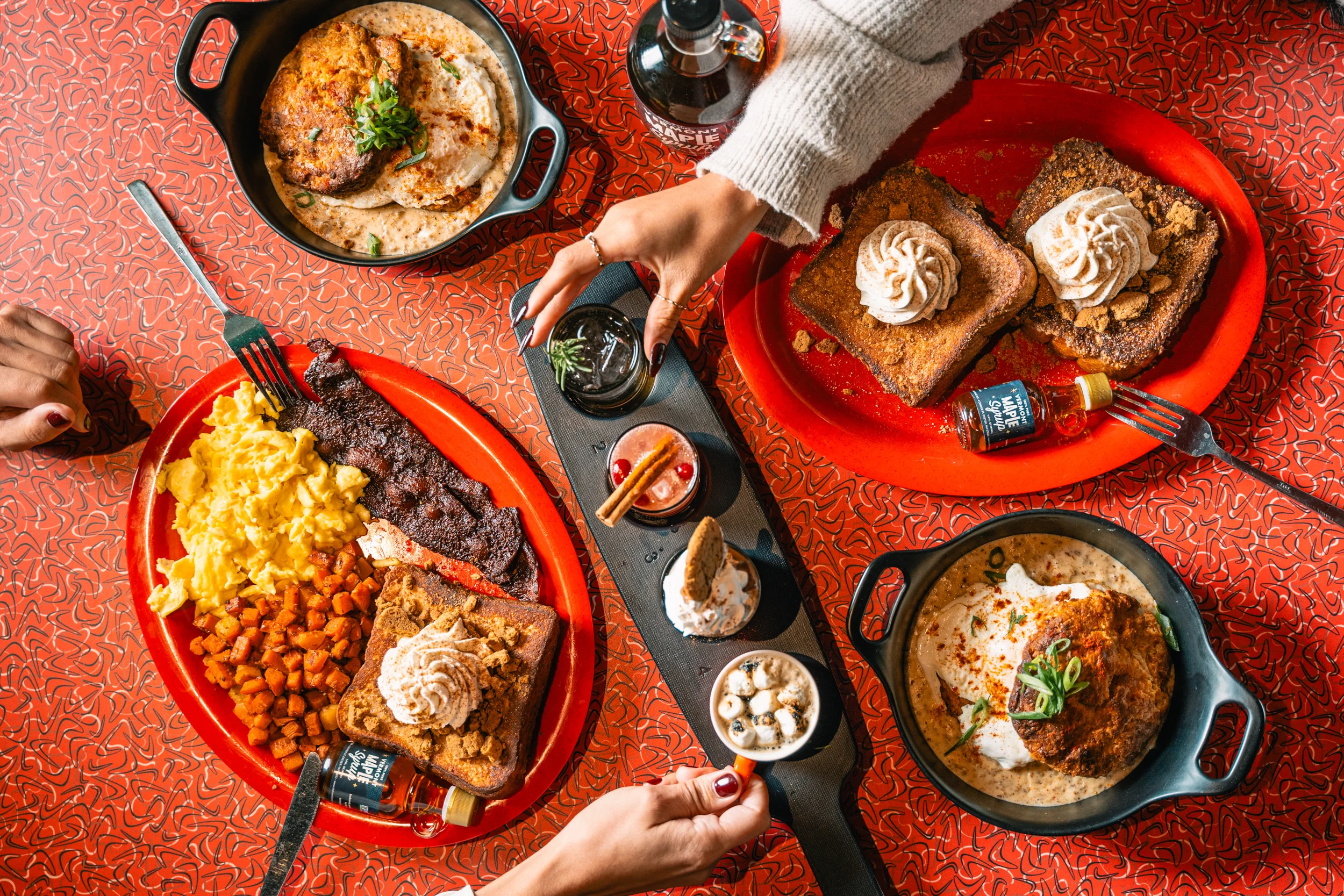Southern brunch spread with chicken and waffles, biscuits, steak, eggs, and French toast