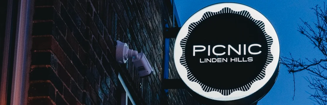 Restaurant sign for Picnic in Linden Hills at dusk