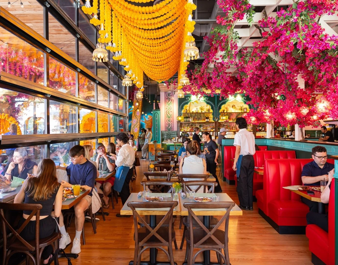 Vibrant restaurant interior with floral decor and lively dining atmosphere