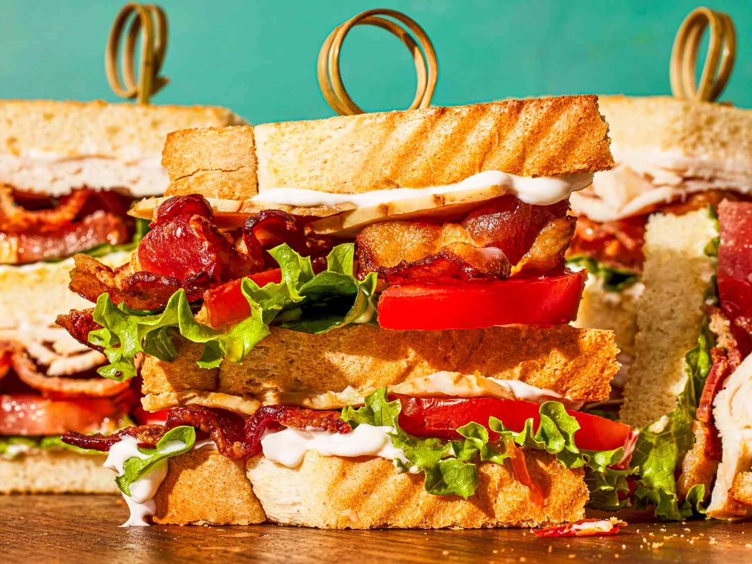 Turkey club sandwich with lettuce, tomato, and bacon on toasted bread