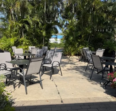 Outdoor dining area surrounded by lush greenery