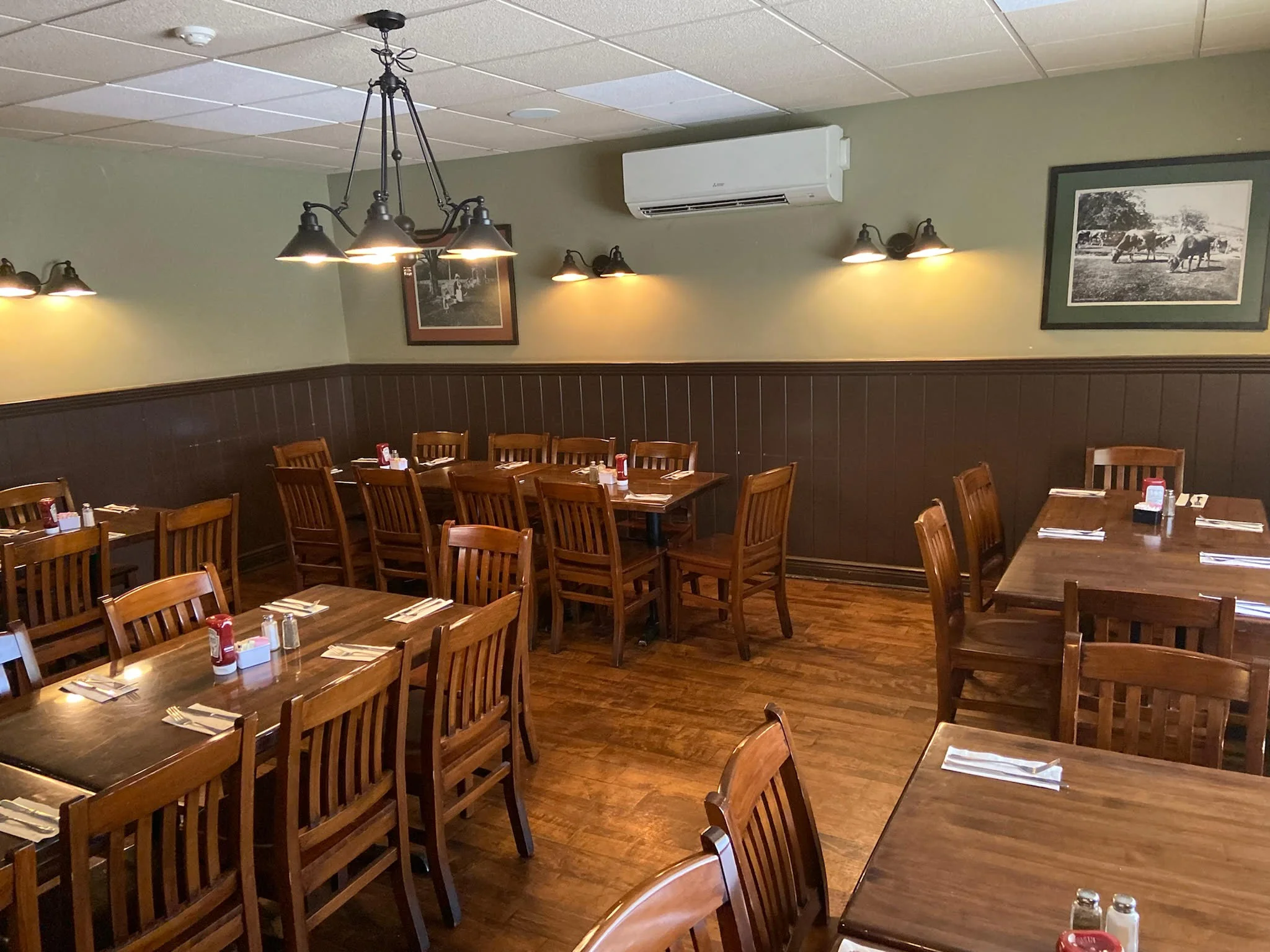 Cozy restaurant interior with wooden tables and warm lighting