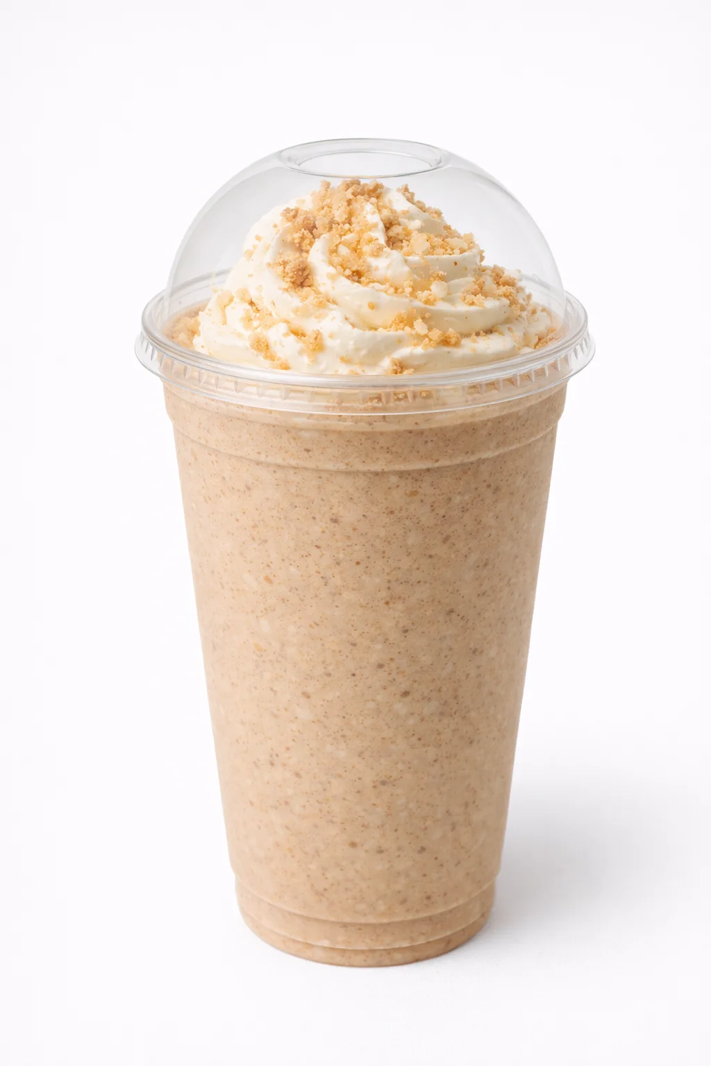 A creamy beverage in a tan color topped with whipped cream and crushed cookie crumbs, served in a clear cup.