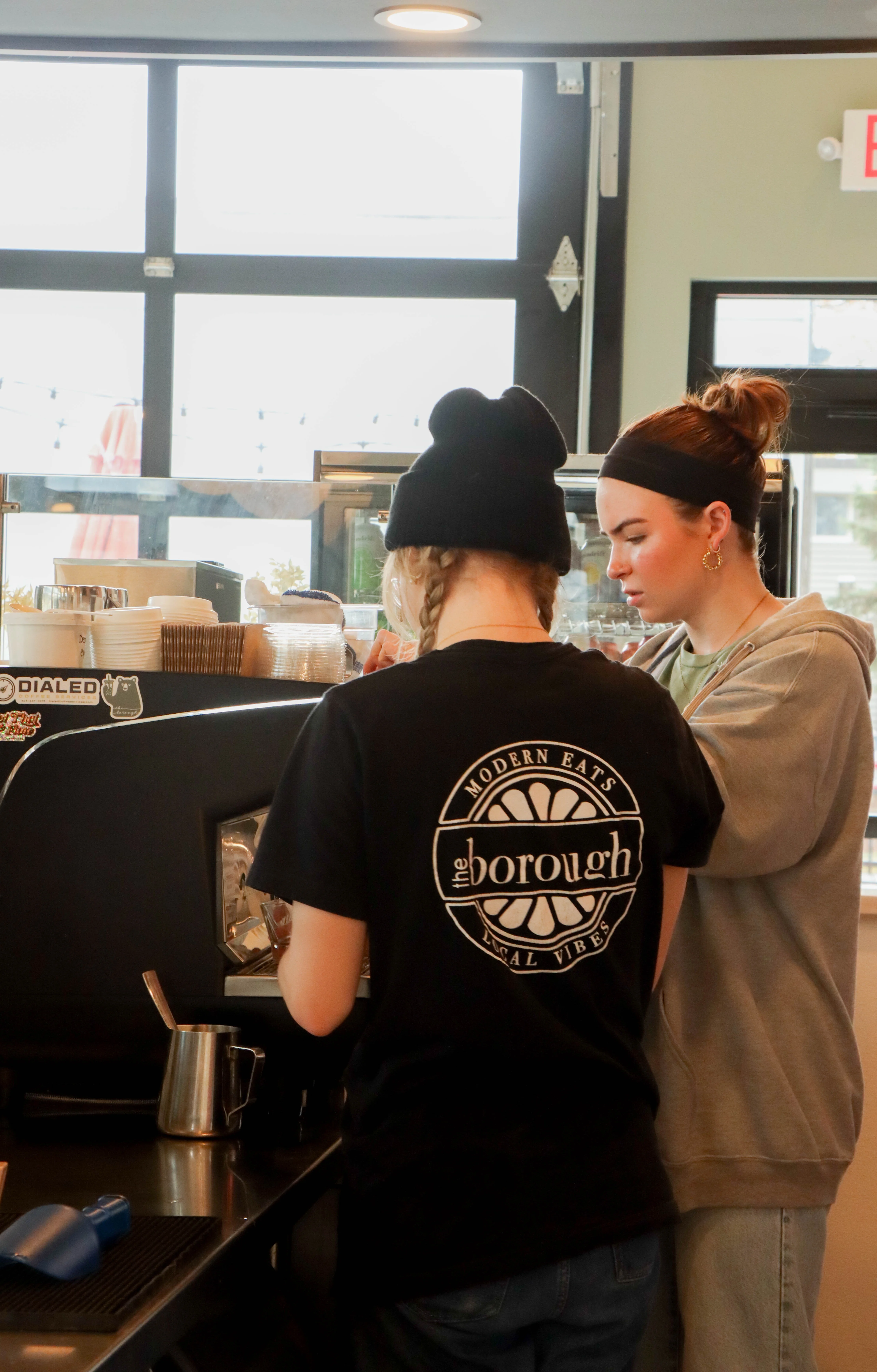 Baristas preparing coffee drinks in a modern café