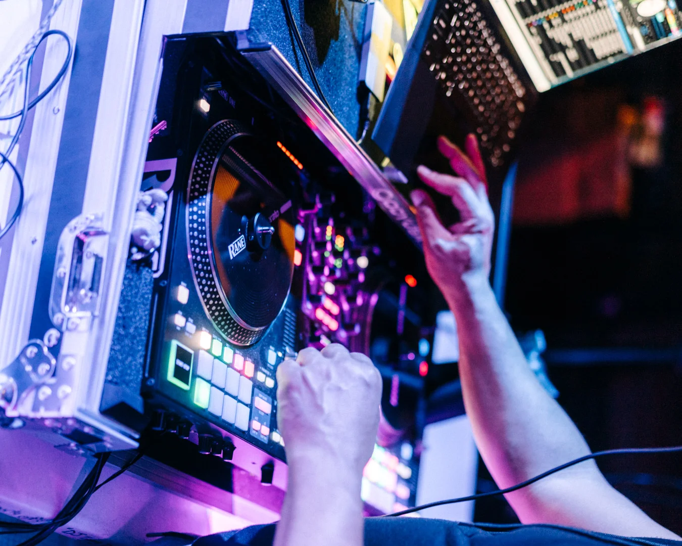 DJ mixing music at a vibrant nightlife event