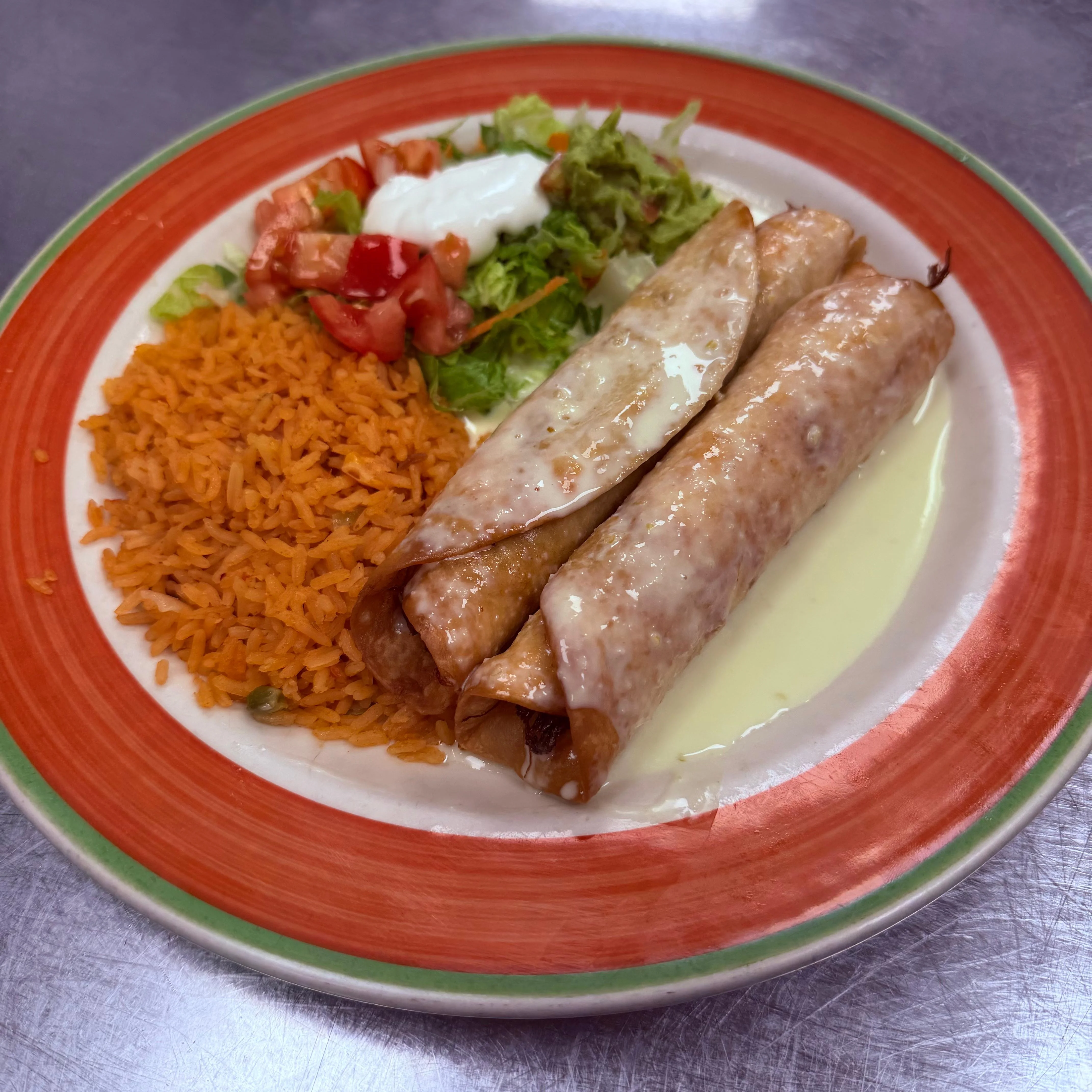Plate of Mexican enchiladas with rice and salad