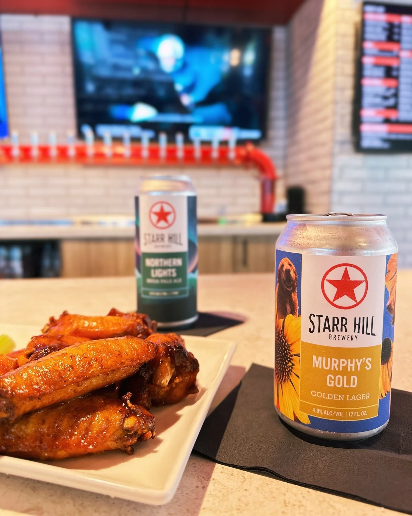Crispy chicken wings with craft beer at a bar